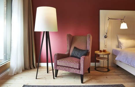 Moderner Sessel mit Stehlampe im stilvollen Hotelzimmer